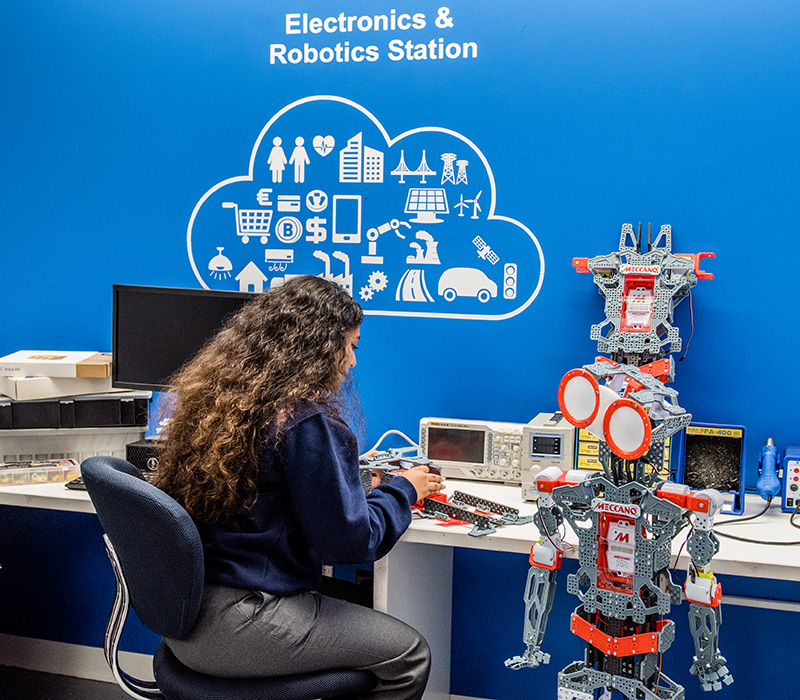 student working in the electronics and robotics station